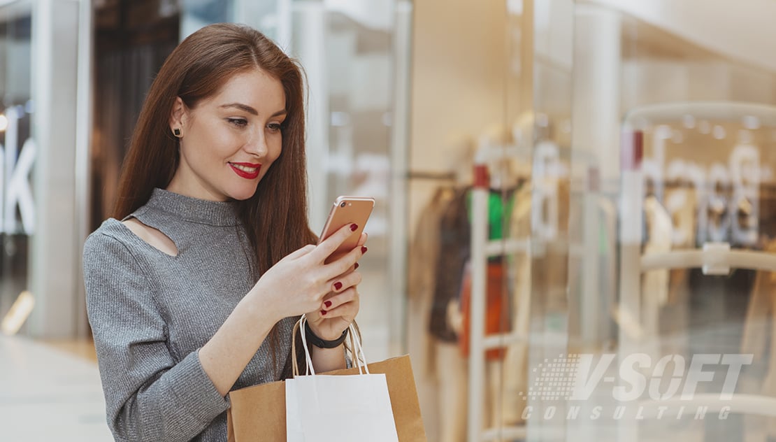 Happy Female Customer looking at her phone on purchasing recommendations