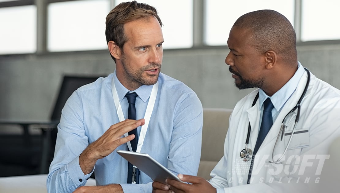 Healthcare professionals analyzing RPA application data on tablet 