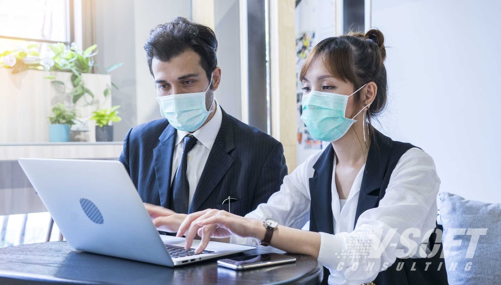 Two employees wearing masks