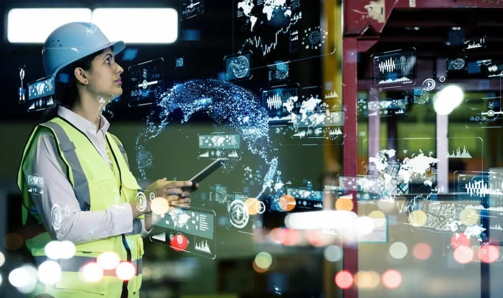 Woman reviewing real-time analytics of her manufacturing operations thanks to IoT data.