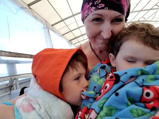 V-Soft Consulting employee hugging her sons during a boat ride of Little Pink House Retreat