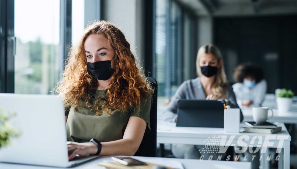 Employees following safety measures in workplace