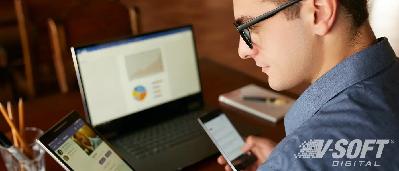 Man using multiple devices with integrated applications.