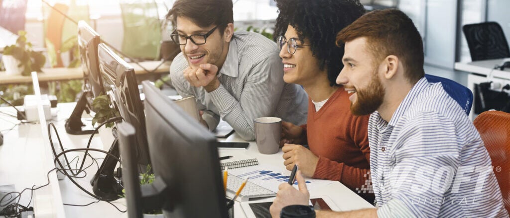 IT professionals and citizen developers working together on computers