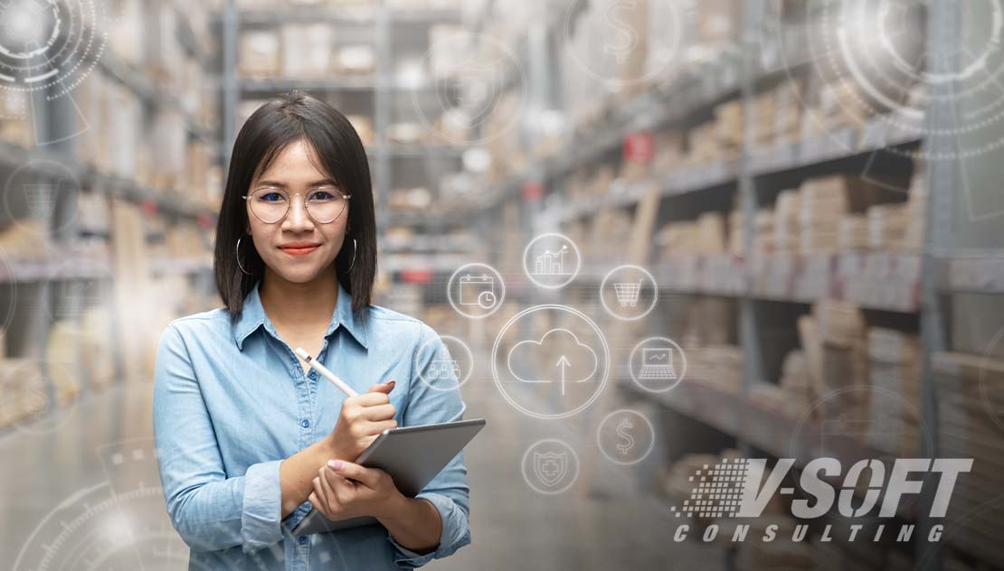 Woman Working in warehouse reviewing IoT data on tablet