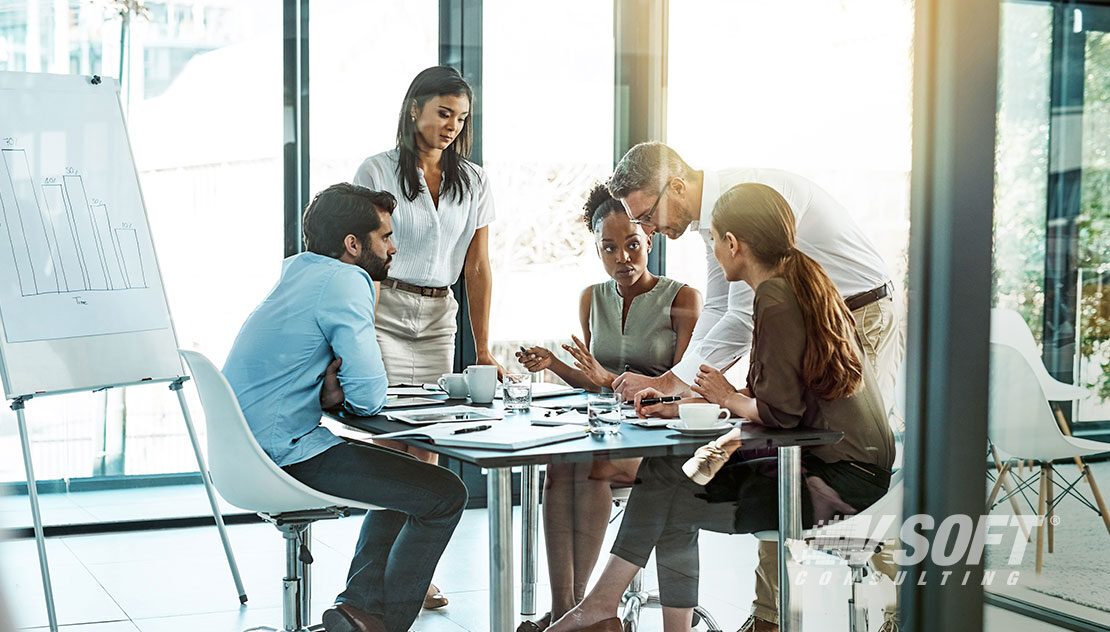 Multiracial team laughing depicting successful workplace services and satisfied employees.